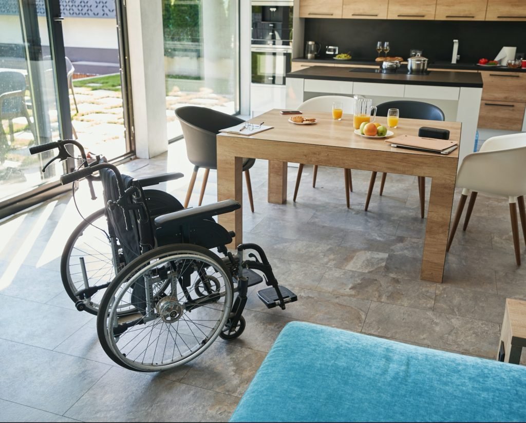 Empty manual wheelchair standing in the kitchen